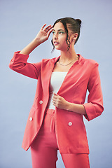 Image showing Fashion, suit and woman in studio thinking, confidence and body in beauty aesthetic. Makeup, style and influencer girl in designer clothes, trendy promo or confident model standing on blue background