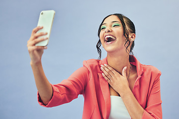 Image showing Phone, laughing selfie and woman with a meme on social media and funny joke for creative job in studio. Web influencer, happy and online with career fashion with blue background and cosmetics