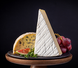 Image showing various cheese pieces on wooden stand