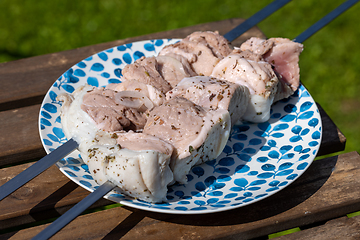 Image showing raw marinated pork skewers