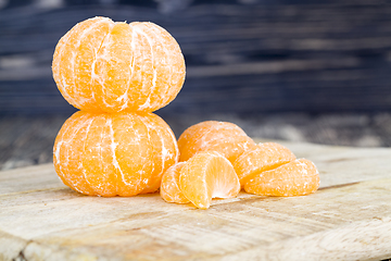 Image showing peeled whole and divided tangerines