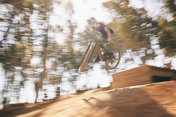 Image showing Motion blur, mountain bike and cycling, man with speed for extreme sports and training in fast adventure. Professional dirt race action, off road bicycle competition or performance challenge in woods