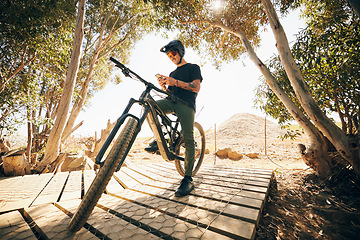 Image showing Bicycle, fitness and man with a smartphone, typing and connection with blog, post and social media. Person, biker and cyclist with a cellphone, digital app and influencer with mobile user and contact