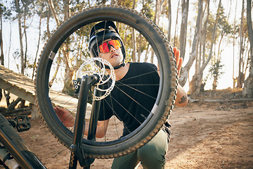 Image showing Nature, man and bike with tire repair, wheel change or maintenance on broken bicycle in forest for workout. Person, cycling and inspection before exercise, training or adventure in woods or path