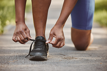 Image showing Person, hands and tie shoes in fitness getting ready running exercise or outdoor cardio workout. Closeup of athlete or runner tying shoe on asphalt in preparation for training or run at the park