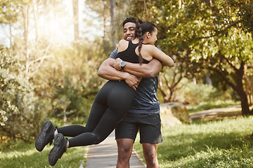 Image showing Fitness, spinning and couple hug in park outdoors for exercise, training and running for cardio workout. Dating, happy and interracial man and woman embrace for wellness, healthy body and sports