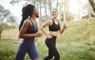 Image showing Happy woman, friends and running in forest for workout, training or outdoor cardio exercise together. Active female person, athlete or runners smile for sports run, sprint or race in nature fitness