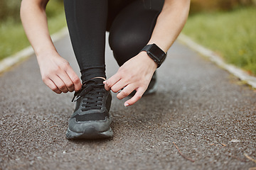 Image showing Person, hands and tying shoes in fitness getting ready running exercise or outdoor cardio workout. Closeup of athlete or runner tie shoe on asphalt in preparation for training or run at the park