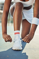 Image showing Woman, shoes and tying laces on tennis court getting ready for sports match, game or outdoor practice. Closeup of female person tie shoe in preparation for fitness, exercise or training workout