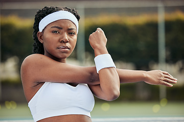 Image showing Sports, portrait and woman tennis player doing warm up for practice to play match at stadium. Fitness, serious and African female athlete with stretching exercise for training on court for tournament