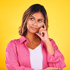 Image showing Woman, thinking and vision on yellow studio background for decision making, solution and inspiration for future choice. Indian, mindset for planning and thoughtful girl with idea, face and reasoning