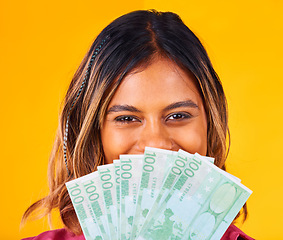 Image showing Woman, eyes and cash fan by face, financial freedom and wealth with winning bonus on yellow background. Money, finance with reward or prize from giveaway in studio, winner in portrait with cashback