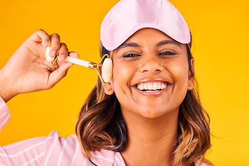 Image showing Face roller, morning and portrait of woman with beauty skincare and smile isolated in studio yellow background for dermatology. Facial, detox and young person calm for care and relax with cosmetic