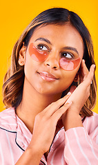 Image showing Eye mask, beauty and woman in a studio with skincare, dermatology and cosmetic product. Glow, smile and young female model from Mexico with facial patch for self care treatment by yellow background.