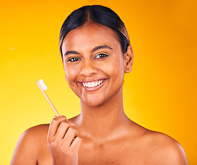 Image showing Woman, toothbrush in portrait with smile and dental in studio, health and wellness on yellow background. Bamboo brush, eco friendly orthodontics and teeth whitening for oral care and fresh breath