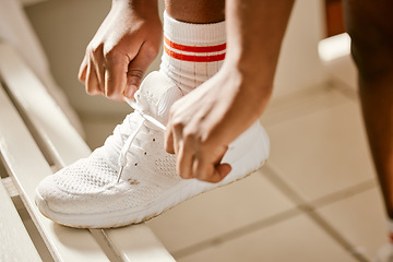 Image showing Locker room, sports and person tie shoes for training, exercise and workout for practice or match. Fitness, gym and closeup of athlete tying laces for performance, wellness and ready for competition