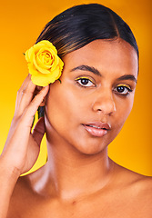 Image showing Skincare, flower and portrait of woman in studio with beauty, glow and cosmetic face routine. Makeup, rose and young female model from Mexico with facial treatment isolated by yellow background.