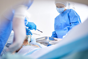 Image showing Tools, hospital and surgeon team in theatre for emergency, healthcare or medical procedure. Doctors with a patient for collaboration, scalpel or surgery and operation with support and scrubs in ICU