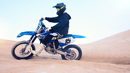 Image showing Dirt, motorbike and athlete or man in sports, adventure and driving on desert, sand dune and outdoor riding in nature. Extreme sport, bike or motorcycle drive with helmet, gear or person with freedom