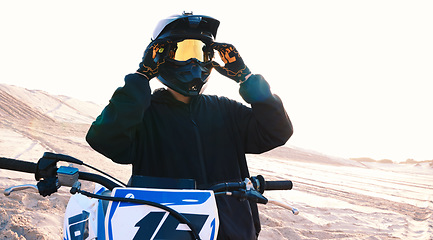 Image showing Helmet, motorcycle and an off road biker outdoor for a race, competition or adrenaline in summer. Freedom, energy and flare with a sports rider on a course for power or speed in a reflective visor