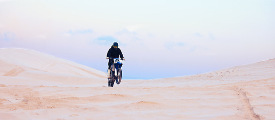 Image showing Rally, desert or athlete driving motorcycle for action, adventure or fitness with performance or adrenaline. Sand, sports or person on motorbike on dunes for training, exercise or race or challenge