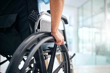 Image showing Hand, rehabilitation and person in a wheelchair at a hospital for medical support, transportation and mobility. Closeup, help and a patient with a disability in a chair at a clinic for recovery