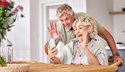 Image showing Senior couple, video call and wave with phone, conversation and contact on social media in retirement. Happy elderly man, woman and webinar with smartphone, smile and hello in morning, house or table