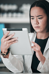 Image showing Tablet, pharmacy and confused Asian woman in laboratory for website, wellness app or telehealth. Healthcare, pharmaceutical and person on digital tech online for medical service, medicine or research
