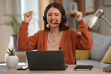 Image showing Woman, headset and laptop in celebration at home with goal, achievement and victory. Female person, consultant or employee with arms up in happiness on video call, telemarketing or support to clients