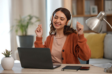 Image showing Woman, laptop and headphones for music, home and dancing at desk with inspiration for remote work. Freelance entrepreneur, audio streaming app and listening to radio with smile, computer and sound