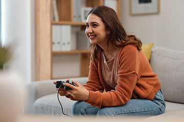 Image showing Happy woman, sofa and playing video games in relax or free time in living room for entertainment at home. Female person smile with controller for console or online gaming on lounge couch in house
