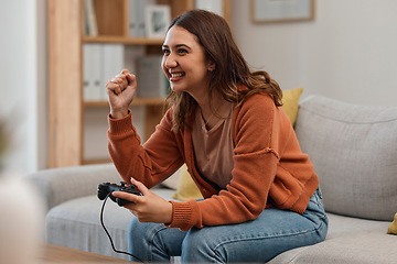 Image showing Success, happy and a woman gaming on the sofa with a win, celebration and excited about competition. Smile, house and a girl with a console for a game, entertainment and achievement with technology