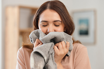 Image showing Clean, laundry and woman smell in home and washing, towel or clothes in apartment with housekeeper or maid. Fresh, scent and person spring cleaning fabric, material or cloth with detergent fragrance