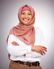 Image showing Portrait, beauty and smile with a muslim woman arms crossed in studio on a gray background. Islam, fashion or culture with a happy mature arab person looking natural or confident in her style