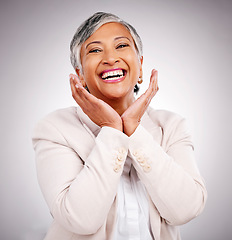 Image showing Portrait, funny and a mature business woman laughing in studio on a gray background for smile or professional growth. Comic, corporate and face frame with happy professional looking confident in suit