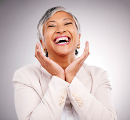 Image showing Portrait, smile and a mature business woman laughing in studio on a gray background for manager or growth. Pride, corporate and face frame with a funny professional looking confident in a suit