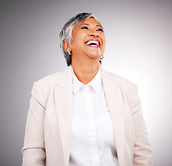 Image showing Smile, funny and a mature business woman laughing in studio on a gray background for vision or growth. Comic, corporate and future with a happy professional looking confident in an executive suit