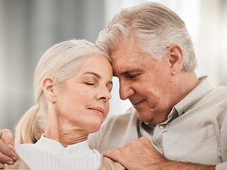 Image showing Old couple, hug and forehead touch, relax on sofa with love and support, bonding while at home with trust and comfort. People together in marriage, partner and retirement with calm and peace of mind