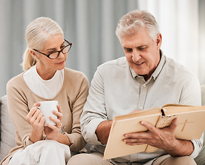 Image showing Bible, reading and senior couple in a living room with book for gospel, discussion or learning in their home. God, worship and elderly man with old woman enjoy retirement with holy, praise or faith