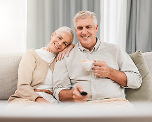 Image showing Old couple, happy on couch with coffee and watching tv, time together in retirement, bonding and love at home. People relax with online streaming, subscription and remote control with tea and a show