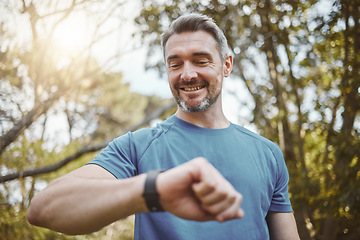 Image showing Happy runner man, smart watch and park for check, smile or reading for time, results or fitness in nature. Person, iot clock and monitor for speed, heart rate or smile for exercise, workout or health