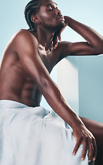 Image showing Art, body and relax black man with style, creative graphic and thinking with fitness and workout in studio. Blue background, male model and muscle with skin glow, power and strong chest with beauty