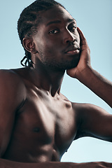 Image showing Black man, beauty with grooming and face, shirtless in studio and isolated on blue background. Hygiene, skincare and African model with muscle, clean dermatology and natural cosmetics in portrait