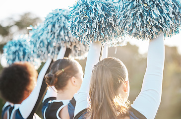 Image showing Cheerleader, sports and women with hands raised on field for performance, dance and game motivation. Teamwork, dancer and people in costume cheer for support in match, competition and event outdoors