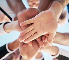 Image showing Hands, together and people in huddle for support and solidarity in community with low angle view. Palm, team building or collaboration with trust, mission in partnership or alliance with synergy