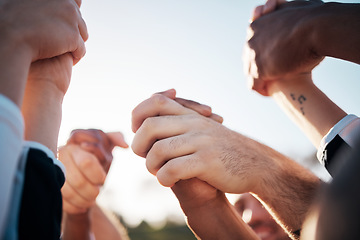 Image showing Holding hands in air, solidarity and support, winning competition and group of people outdoor. Celebrate, mission and partnership with community, closeup of synergy and success in contest with power