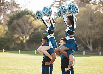 Image showing Cheerleader, sports and men carry women on field for performance, dance and motivation for game. Teamwork, dancer and people balance and cheer for support in match, competition and event outdoors