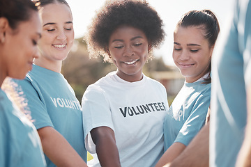 Image showing Diversity, smile and a volunteer group in a huddle outdoor for charity, community or activism together. Teamwork, climate change and recycling with eco friendly people in the park for a green planet