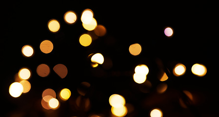 Image showing Yellow, bokeh and light in a studio with a dark background for celebration, event or party. Mockup, sparkle and gold for glow, magic or shine for festive decoration by a black backdrop with mock up.