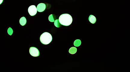 Image showing Bokeh on a dark background, green dots and sparkle with mockup space, abstract or wallpaper with special effects. Texture, pattern and glitter, graphics with glow or shine, disco with bubble decor